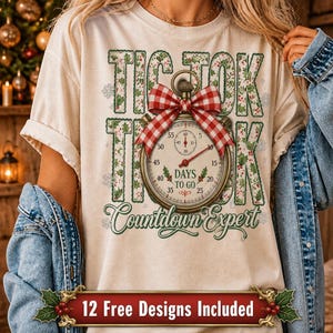 May include: A cream-colored t-shirt featuring a graphic of a stopwatch with a red and white checkered bow. The text reads TIC TOK THOK DAYS TO GO and Countdown Expert, surrounded by holly and snowflake patterns. A red banner at the bottom says 12 Free Designs Included.