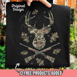 May include: Black sweatshirt featuring a deer head and crossed rifles design. The deer head and rifles have a camouflage pattern. The words "Original Design" are at the top left. The text "12 FREE PRODUCTS ADDED" is at the bottom.