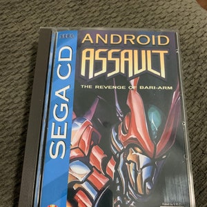 May include: A Sega CD game case with a red, blue, and black design. The game is called "Android Assault: The Revenge of Bari-Arm".