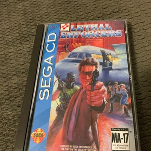 May include: A Sega CD game case for the game Lethal Enforcers. The case is blue and white with a picture of a man holding a gun. The game is rated MA-17 for Mature Audiences.