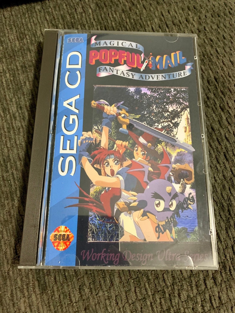 May include: A SEGA CD game case for "Magical Pop'n" featuring a colorful fantasy adventure scene. The case has a blue spine with "SEGA CD" printed vertically. The game's title is in a stylized font, and the case is in a clear plastic sleeve.