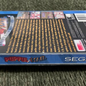 May include: A SEGA CD game case for "Popful Mail: Magic Fantasy Adventure." The case is clear plastic with a blue border and features colorful graphics and text. The game's title is prominently displayed.