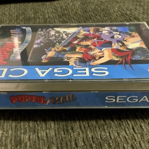 May include: A SEGA CD game case for Popful Mail: Fantasy Adventure. The case is clear with a blue band that reads "SEGA CD" and "Popful Mail". The game cover art features anime-style characters with swords.