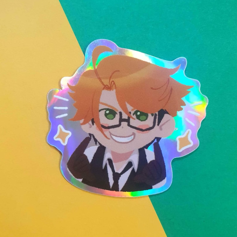 May include: Holographic sticker featuring a cartoon character with orange hair, glasses, and a black suit. The character is smiling with green eyes. The sticker has a star and a holographic effect. The background is yellow and green.