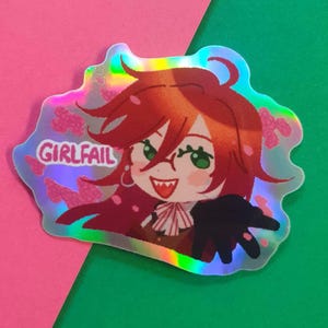 May include: Holographic sticker featuring a cartoon character with red hair, green eyes, and glasses. The character is smiling with sharp teeth and wearing a black outfit. The sticker has the text "GIRLFAIL" and pink butterfly accents.