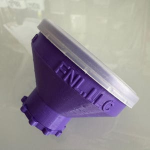 May include: Purple plastic funnel with a clear plastic lid. The funnel has a gear-like base and the text "FNL, LLC" is printed on the side.