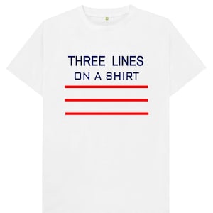 May include: White t-shirt with the text "THREE LINES ON A SHIRT" in navy blue and three red horizontal lines.