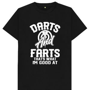 May include: Black t-shirt with white text that reads "Darts And Farts That's What I'm Good At". The text is in a bold, playful font. A stylized dartboard with darts is above the text.