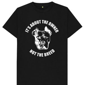 May include: Black t-shirt with a white silhouette of a pit bull dog and the text "It's about the owner not the breed".