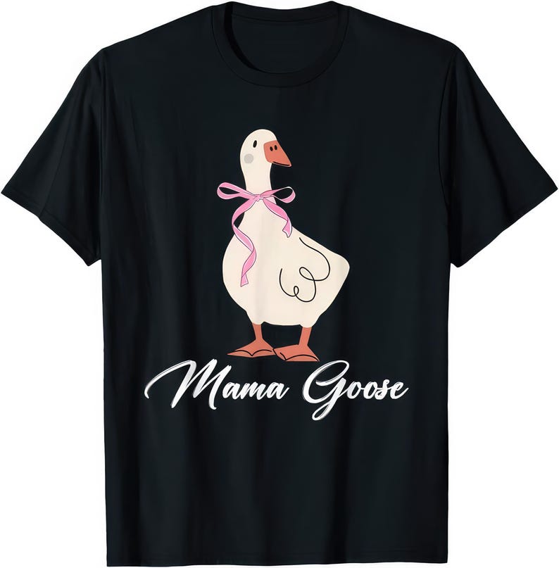 May include: Black t-shirt featuring a cartoon goose with a pink bow and orange feet. The goose has a white body and a brown beak. The words "Mama Goose" are written in white script below the goose.