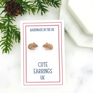 May include: A pair of brown mouse stud earrings on a white card with the text "Handmade in the UK" and "Cute Earrings UK".