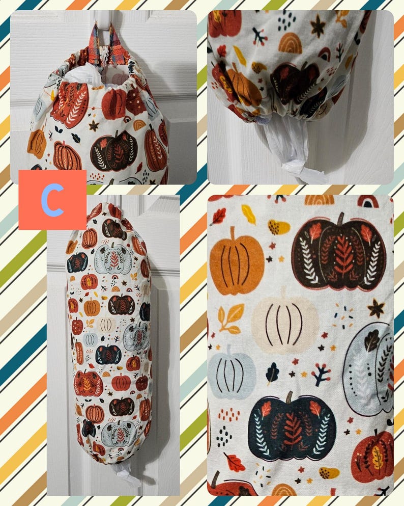 May include: A white fabric bag with a pumpkin pattern in orange, brown, and blue. The bag is designed to hold plastic grocery bags and has a drawstring closure. The bag is hanging on a hook.