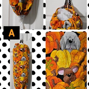 May include: A reusable grocery bag dispenser with a fall-themed fabric featuring pumpkins, leaves, and cartoon dogs. The fabric is orange, yellow, brown, and black.