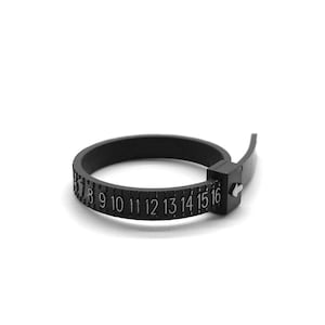 May include: Black plastic ring size gauge with numbers 7 through 16 printed on it.