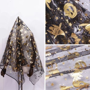 May include: Black sheer fabric featuring gold Halloween motifs such as pumpkins, bats, and stars. The fabric is draped, displaying the pattern. Suitable for costumes or decorations.