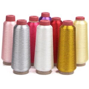 May include: A collection of colorful spools of metallic thread. The spools are in various colors, including pink, silver, red, white, gold, and yellow. Each spool has a brown base and a red top.
