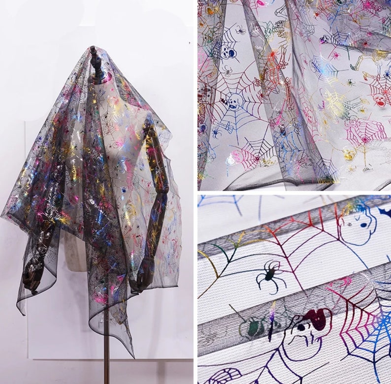 May include: Black sheer fabric with a Halloween design. The fabric is decorated with colourful spiderwebs, spiders, and skeleton graphics. The fabric is draped over a mannequin, showing its texture and pattern.