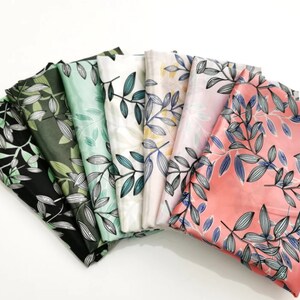 May include: A collection of folded fabric pieces in various colors, each adorned with a botanical leaf pattern. The color palette includes black, green, mint, white, pink, and coral. The leaves are detailed with blue and gray accents.