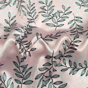 May include: A close-up of a pink fabric with a repeating pattern of stylized leaves. The leaves are in shades of gray and black, with a delicate, hand-drawn appearance. The fabric has a subtle sheen.