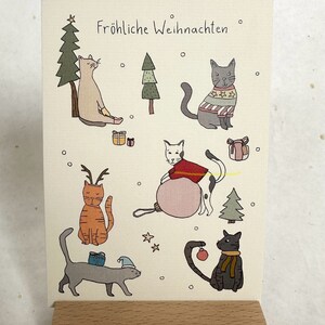 Weihnachtskarte - fröhliche Weihnachten mit fröhlichen Katzen