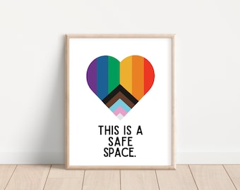 May include: A framed print with a rainbow heart and the text "This is a safe space."