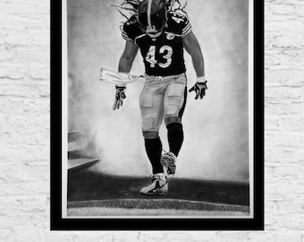 May include: Black and white pencil drawing of a football player wearing a jersey with the number 43. The player is running with the ball and his hair is blowing in the wind.