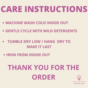 May include: Pink and white care instructions for a garment. The instructions include machine wash cold inside out, gentle cycle with mild detergents, tumble dry low or hang dry to make it last, and iron from inside out. The text also includes "Thank you for the order" and a lightbulb graphic with the text "Inspiremefundesigns Be Inspired & Smile".