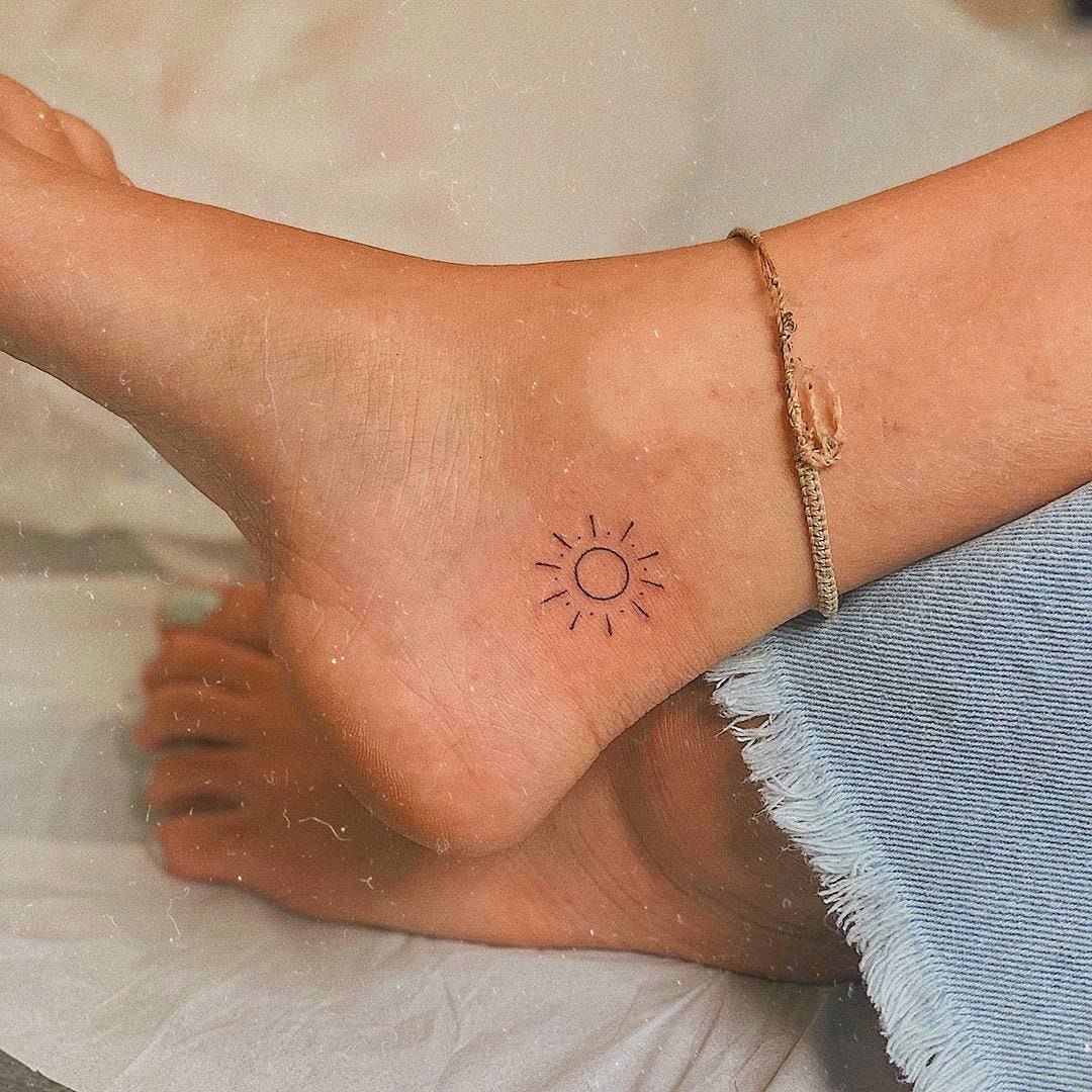 Minimalist moon and plane tattoo on the ankle.