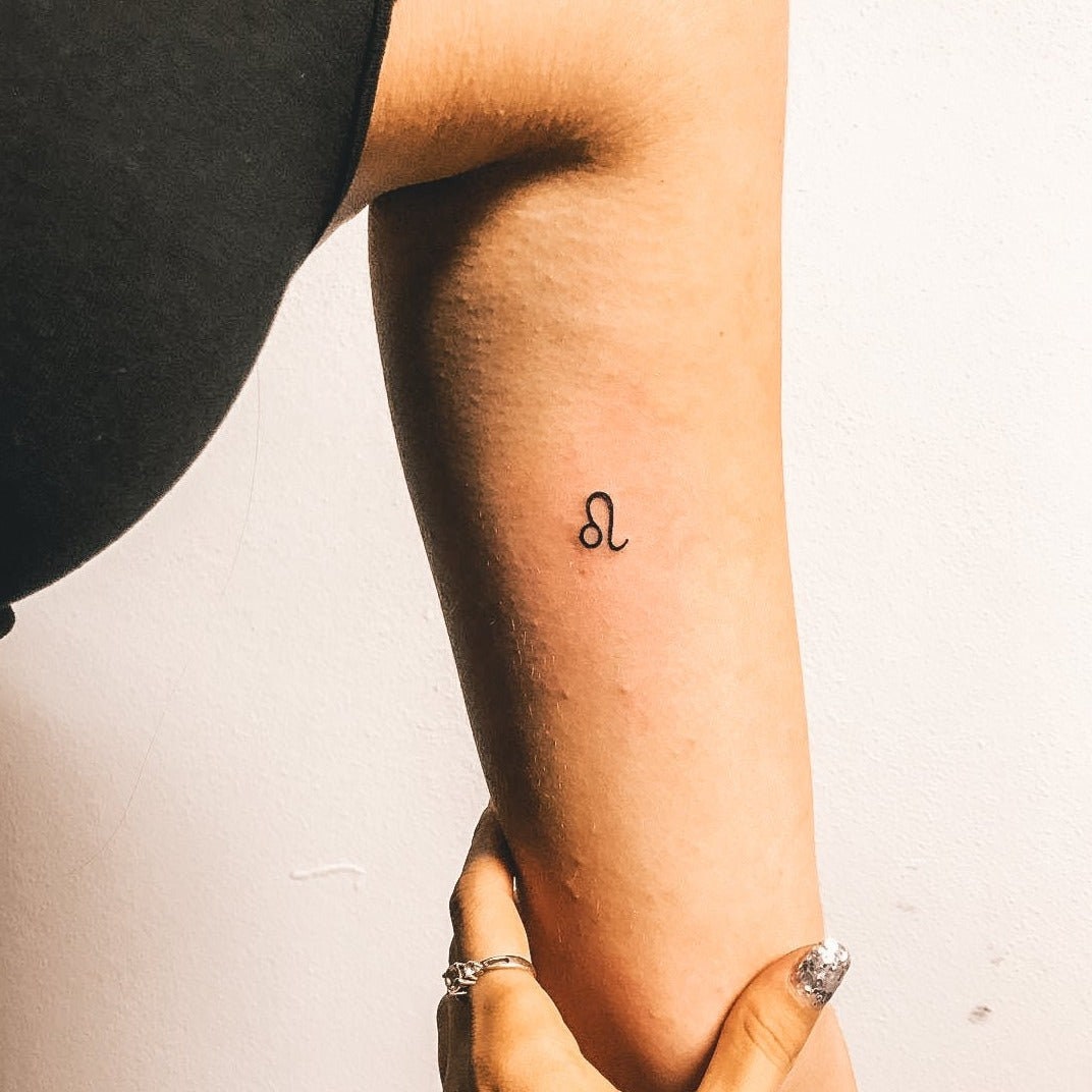 Minimalist zodiac symbols tattoo on the wrist