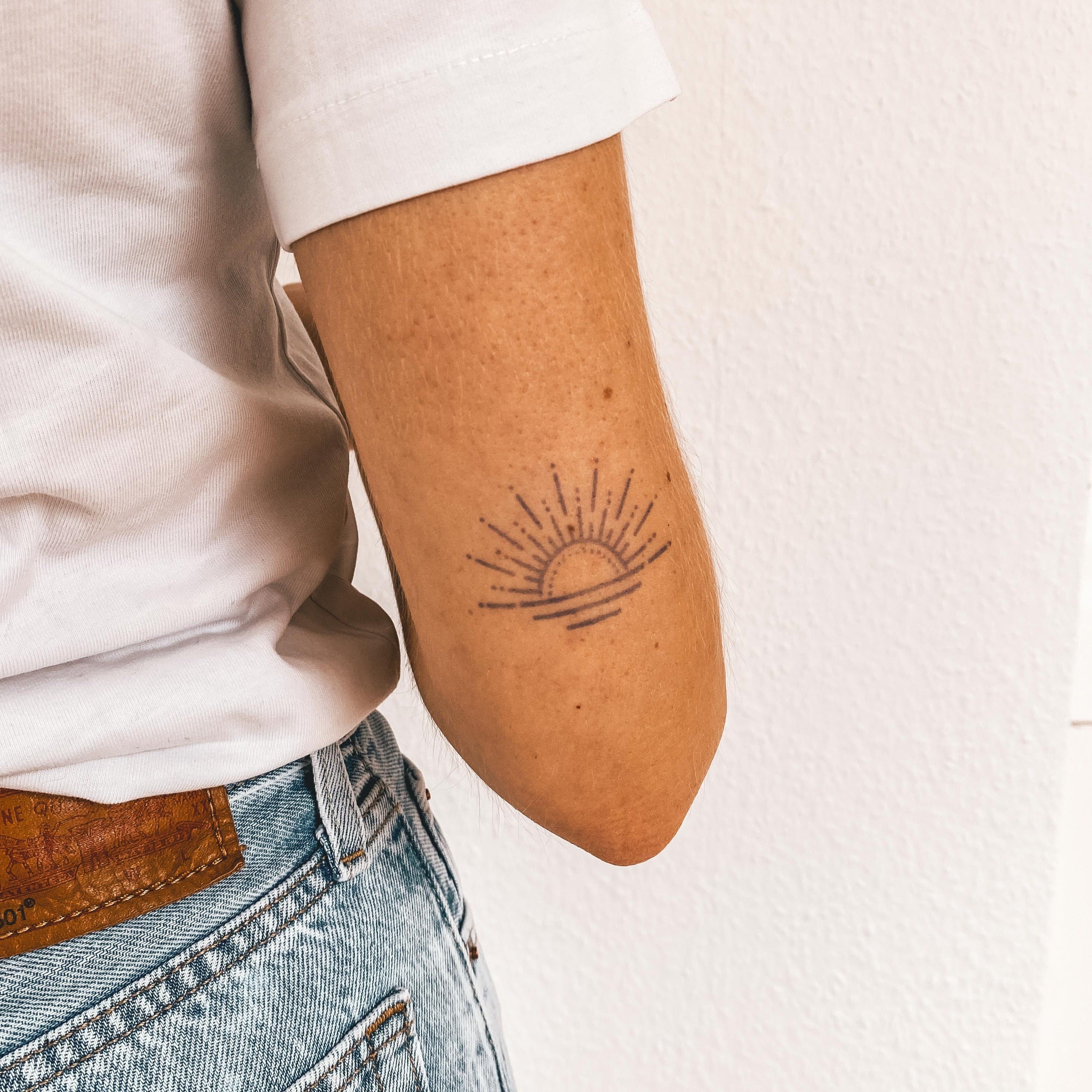 Minimalist black sunrise tattoo on the right arm | Sun tattoo designs, Sunrise  tattoo, Tattoos for guys
