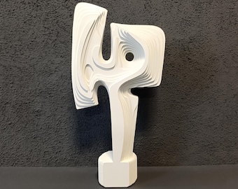 May include: White abstract sculpture with a layered, organic design. The sculpture is made of paper and has a smooth, matte finish.