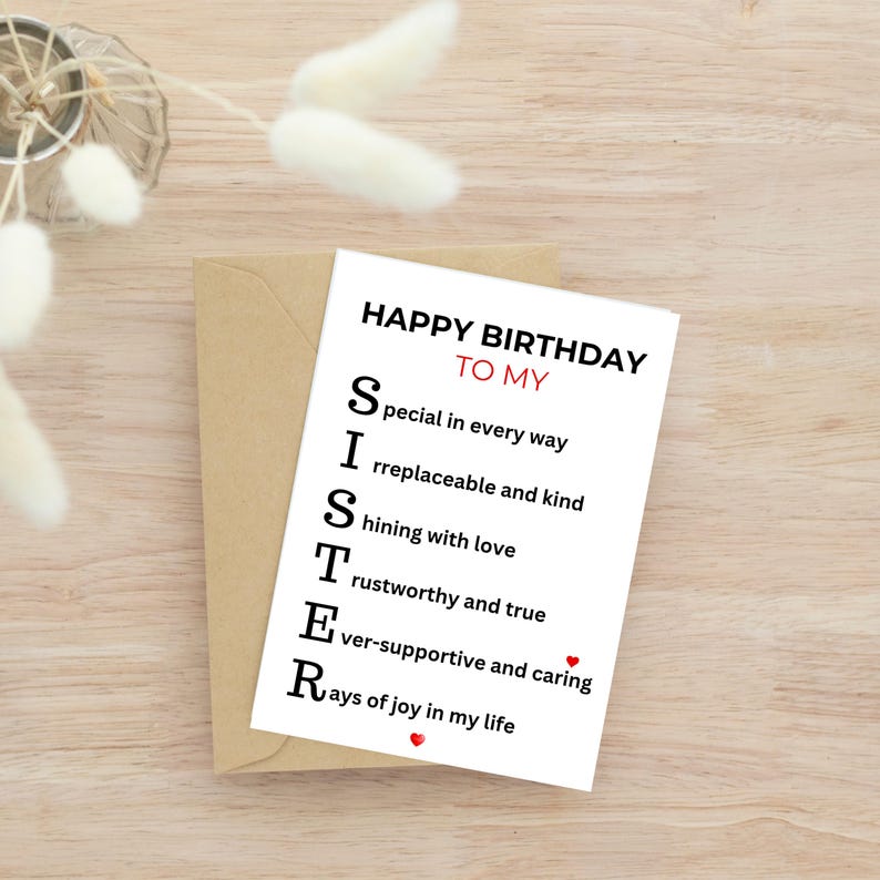 May include: A birthday card with the message "Happy Birthday To My Sister" in black text. The card's message is an acrostic poem, with each letter of "SISTER" spelling out a positive attribute. The card is on a wooden surface.