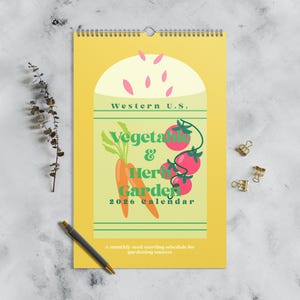 May include: A yellow 2026 calendar with a spiral binding, featuring a vegetable and herb garden theme. The design includes illustrations of carrots and tomatoes, with the text "Western U.S." and "Vegetable & Herb Garden". The calendar also includes the text "A monthly seed starting schedule for gardening success".