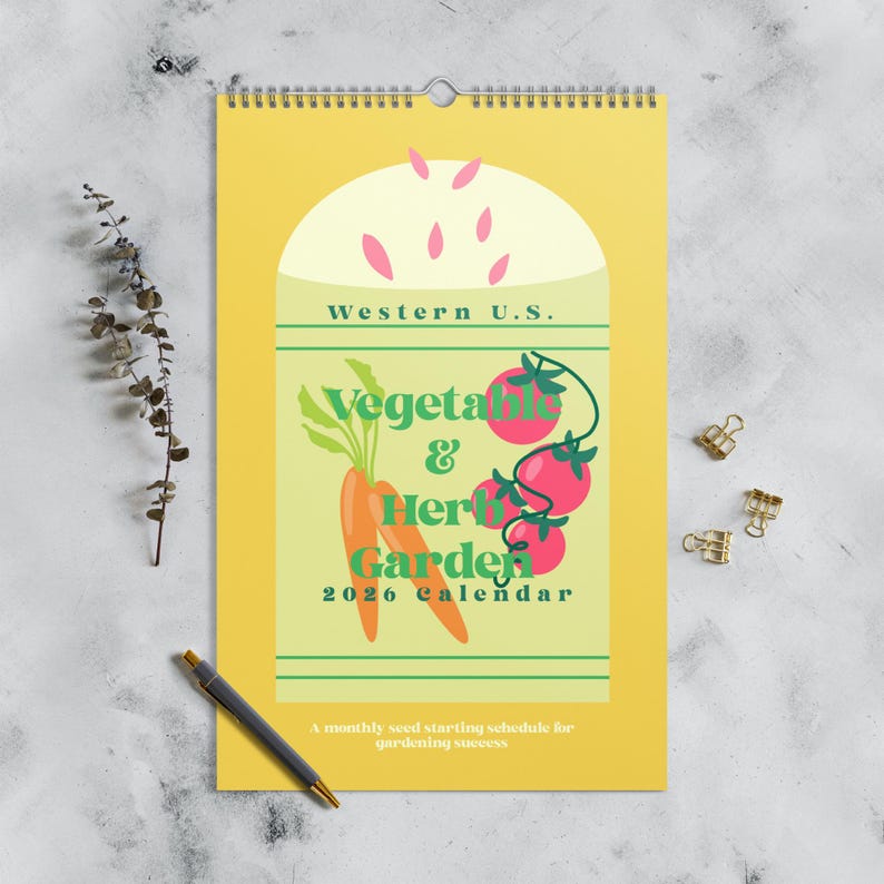 May include: A yellow 2026 calendar with a spiral binding, featuring a vegetable and herb garden theme. The design includes illustrations of carrots and tomatoes, with the text "Western U.S." and "Vegetable & Herb Garden". The calendar also includes the text "A monthly seed starting schedule for gardening success".