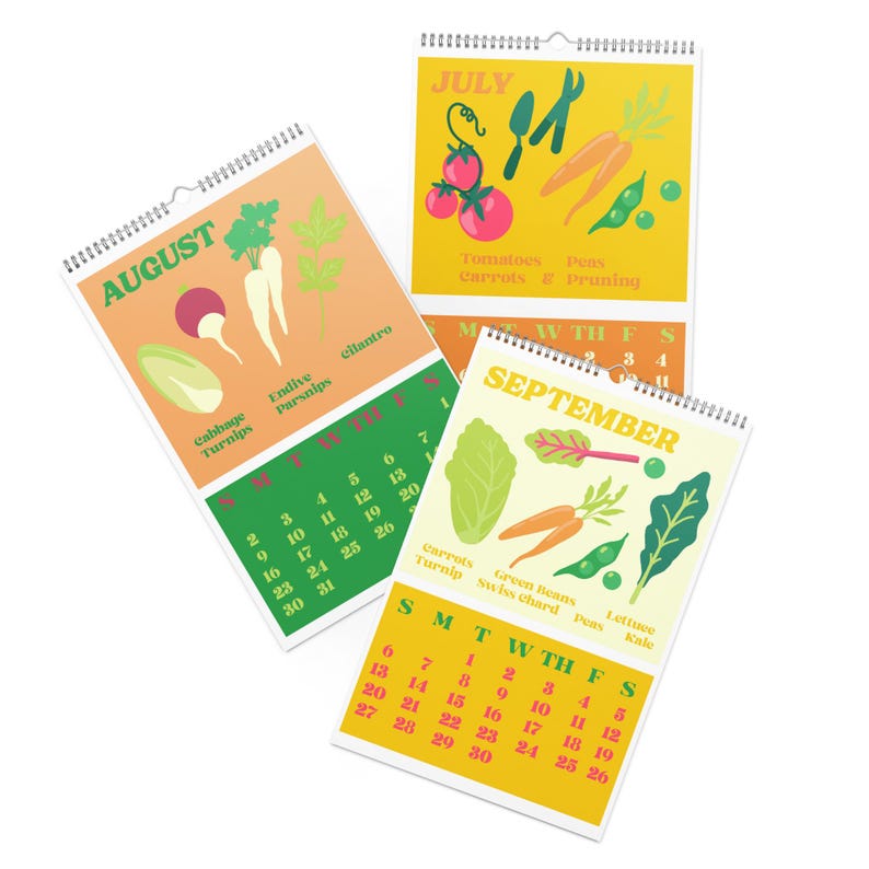 May include: Three spiral-bound calendars with monthly pages for July, August, and September. Each page features illustrations of vegetables like tomatoes, carrots, and lettuce, with the month's name at the top and a calendar grid below.
