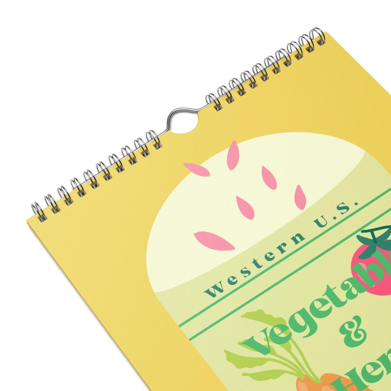 May include: A spiral-bound calendar with a yellow cover featuring a design of vegetables and herbs. The text "Western U.S. Vegetables & Herbs" is visible. The calendar has a metal spiral binding and a hole for hanging.