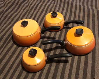 Vintage orange and black aluminium four piece saucepan set