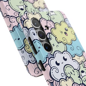 May include: A phone case with a colorful cartoon design featuring clouds with faces. The case has a cutout for the camera lens.