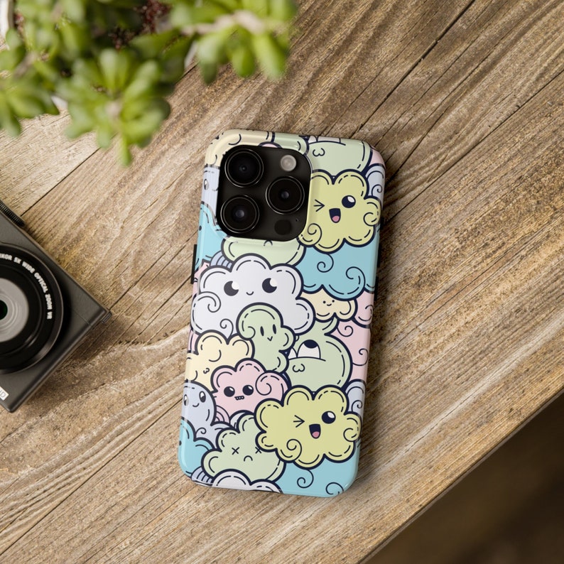 May include: A phone case with a colorful cartoon design featuring clouds with faces. The case is white with a variety of pastel colors, including blue, green, yellow, and pink.