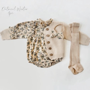 May include: A four-piece baby outfit set in oatmeal color. The set includes a floral print bodysuit, a knitted cardigan, and a pair of tights. The cardigan has a scalloped neckline and button closure. The headband is not included.