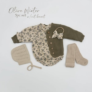 May include: Olive Winter 5pc set w/oat bonnet. A baby outfit set with a floral print romper, a green cardigan, a pair of tights, and a crocheted bonnet.