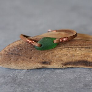 Handmade beachy casual real green sea glass bracelet on tan leather cord, with cop components, wire wraps, and lobster claw clasp