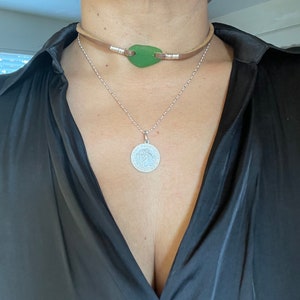 Green sea glass choker on brown soft leather cord with silver wire wrap components. (The choker is about 14 inch long)
