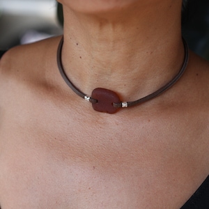 Brown sea glass choker on brown leather cord with silver components. (The choker is about 14.75 inch long)