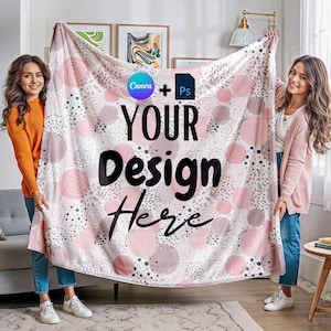 May include: Two people are holding up a pink and white fleece blanket with a circle pattern. The blanket has the text "Canva + Ps YOUR Design Here" printed on it.