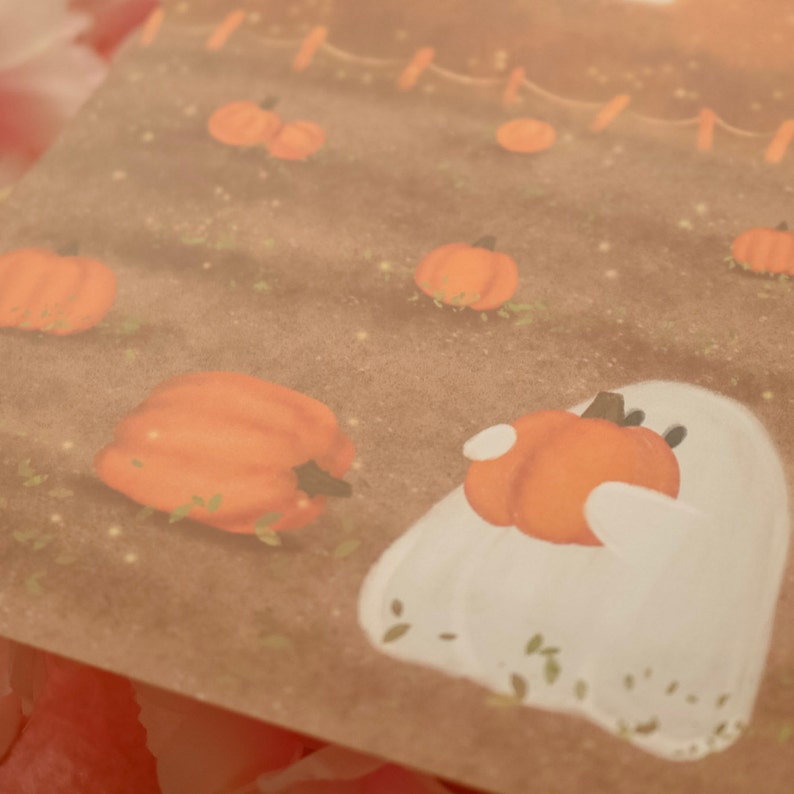 May include: A white ghost with a friendly expression holds a small orange pumpkin in its arms. The ghost is surrounded by a field of orange pumpkins on a brown background.