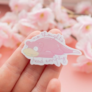 May include: A pink sticker with a cartoon pink Pokemon character with the text "no thoughts head empty".