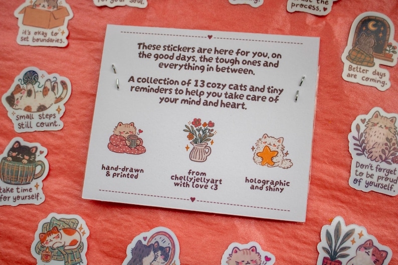 May include: A white rectangular card featuring text about a collection of 13 cat stickers. The card displays illustrations of a cat with a mug, a flower vase, and a cat holding a star. Surrounding the card are various cat-themed stickers.