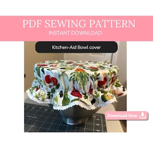May include: A white Kitchen-Aid bowl cover with a colorful vegetable print and a white lace trim. The cover is on a silver bowl. The text "Kitchen-Aid Bowl cover" and "Download Now" are visible in the image.