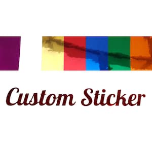 Puede incluir: Pegatina personalizada con una variedad de colores, incluyendo dorado, rojo, azul, verde y naranja. La pegatina está hecha de un material brillante y reflectante.